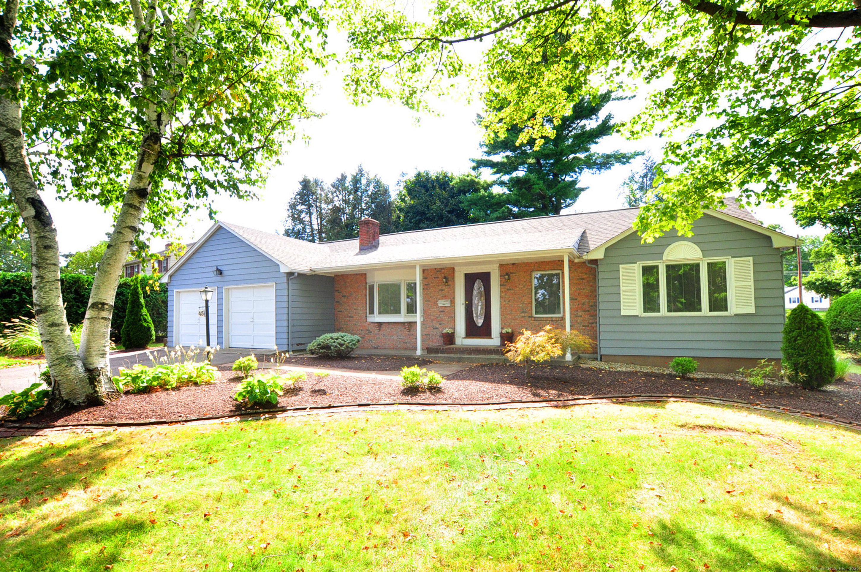 a front view of house with yard outdoor seating and barbeque oven