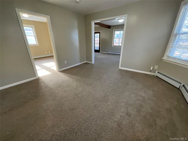 an empty room with windows and entrance