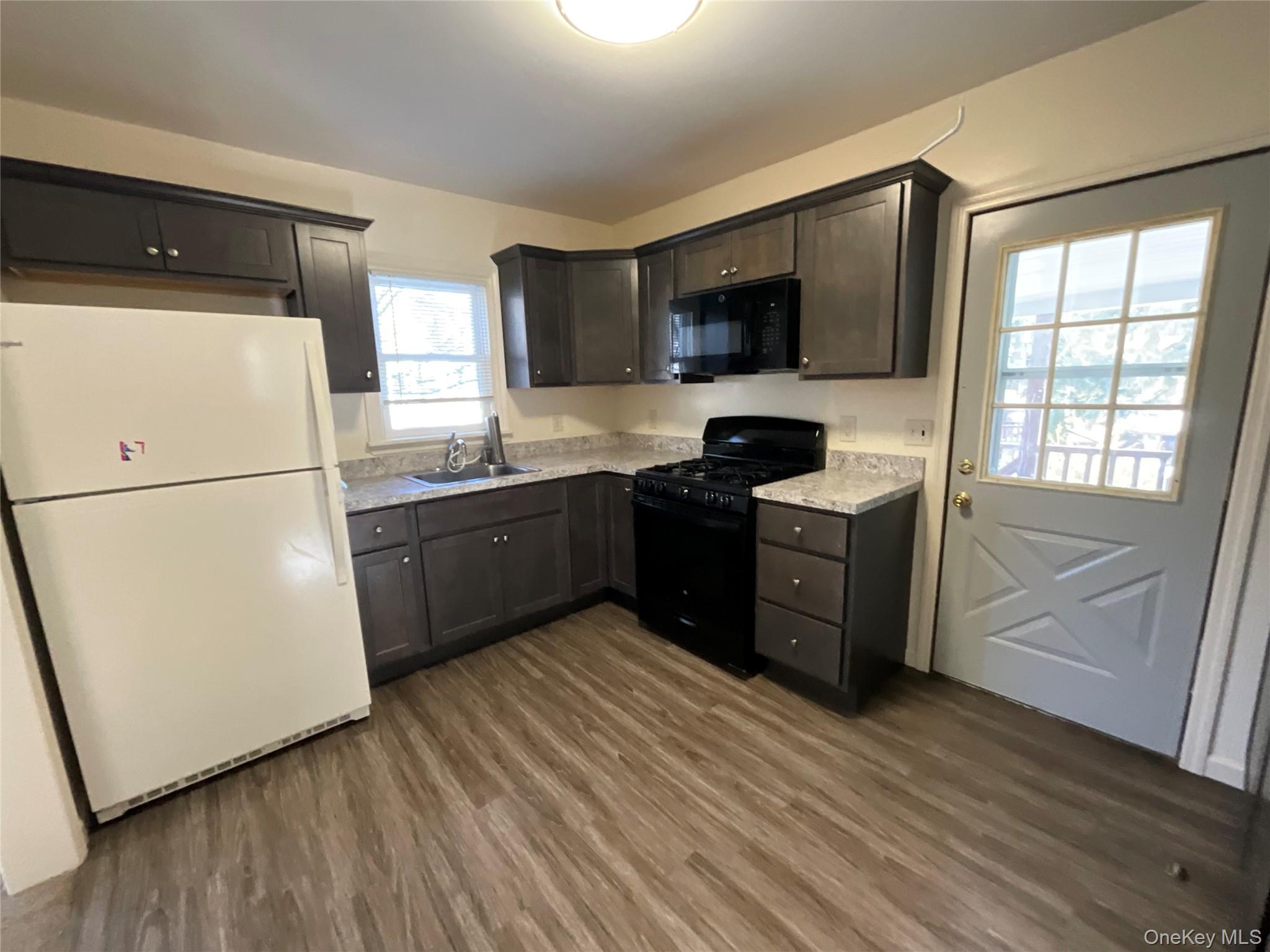 32 Prairie Avenue, Unit B Suffern, NY 10901 - Photo 22 of 26 a kitchen with stainless steel appliances granite countertop a stove a sink and a refrigerator
