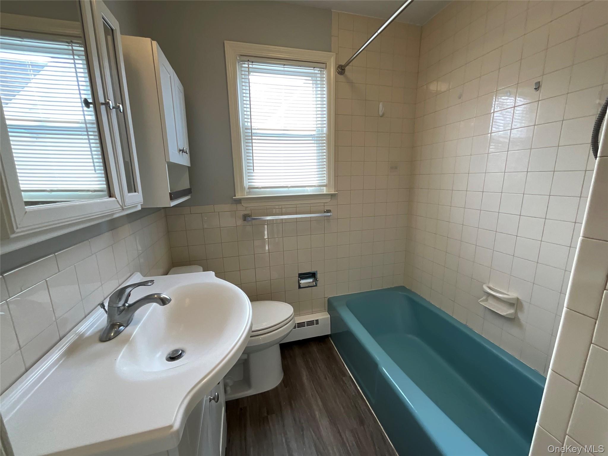32 Prairie Avenue, Unit B Suffern, NY 10901 - Photo 23 of 26 a bathroom with a sink a toilet and a tub