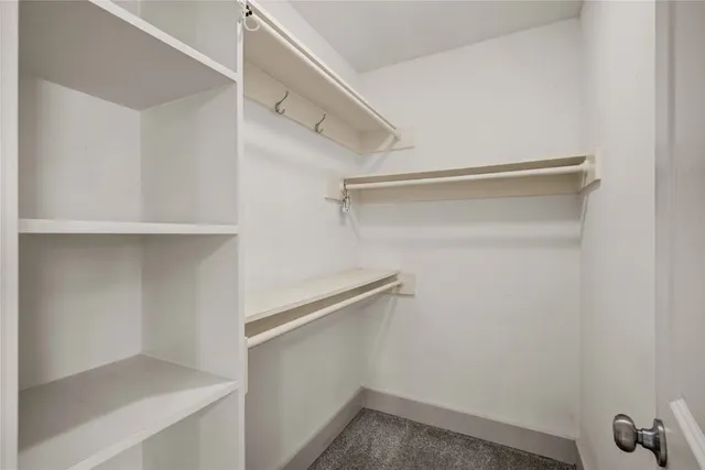 a bedroom with a bed and a ceiling fan