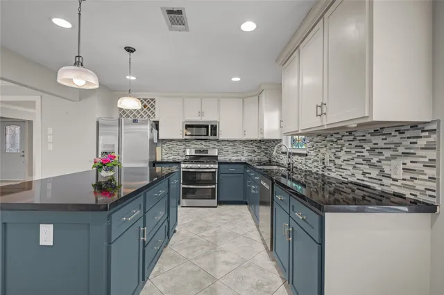 a kitchen with stainless steel appliances granite countertop a sink and a cabinets