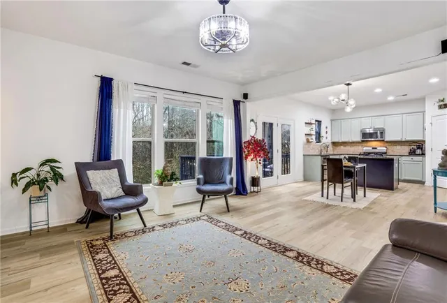 a living room with furniture and a chandelier