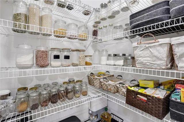 a room with stainless steel appliances kitchen island granite countertop stove and cabinets