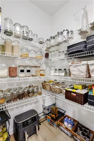 a bedroom with furniture and a wooden floor