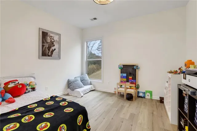 a bedroom with a bed and a couch