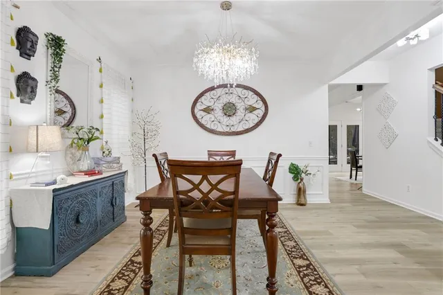 a view of a dining room with furniture and chandelier