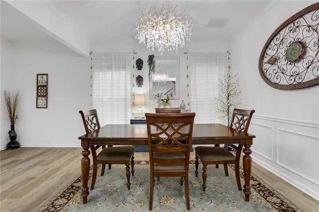 a view of a dining room with furniture and a chandelier