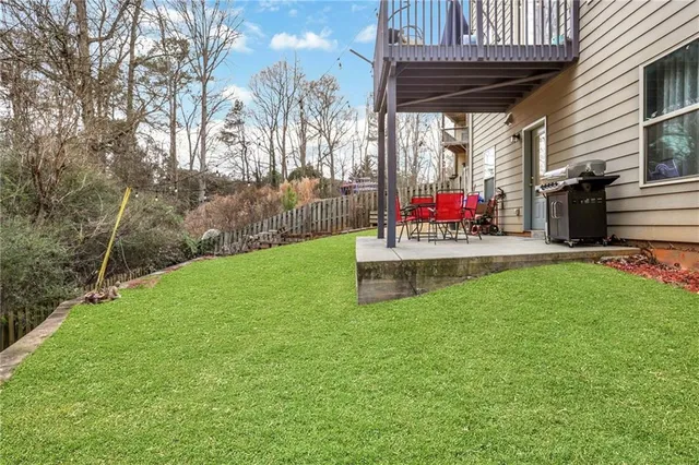a view of a swimming pool with a yard and plants