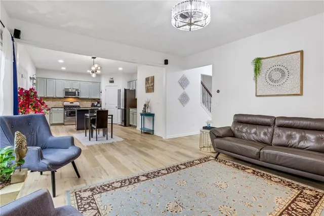 a living room with furniture and kitchen view