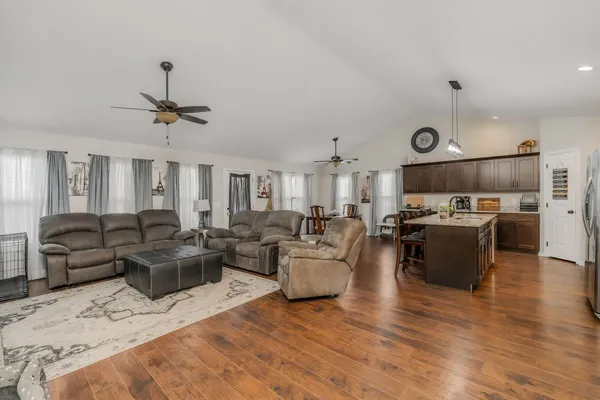 a living room with furniture and a wooden floor