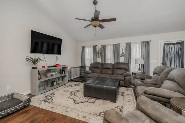 a living room with furniture and a flat screen tv