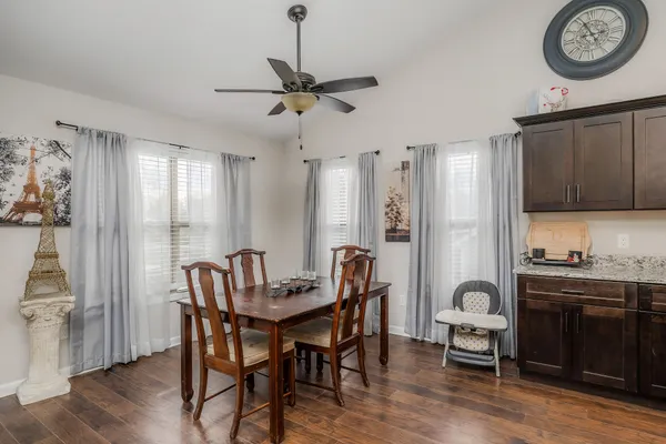 a view of a dining room with furniture window and wooden floor