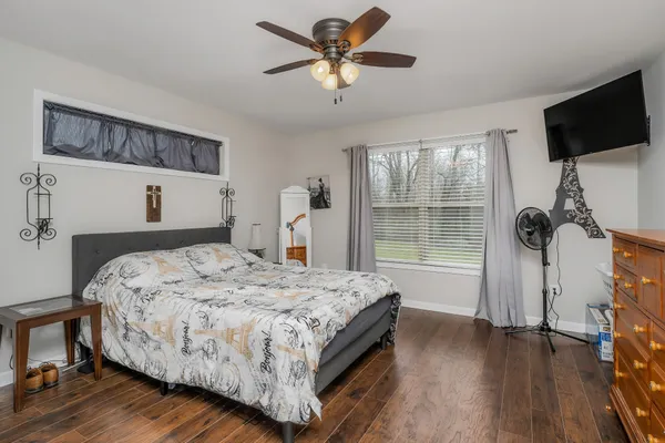 a bedroom with a bed and a window