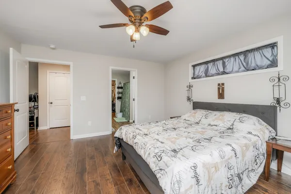 a bedroom with a bed and a chandelier