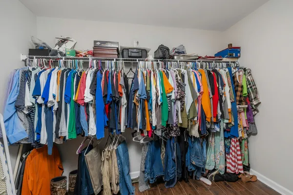 a view of walk in closet with clothes