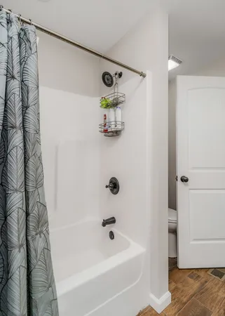 a bathroom with a bathtub and shower