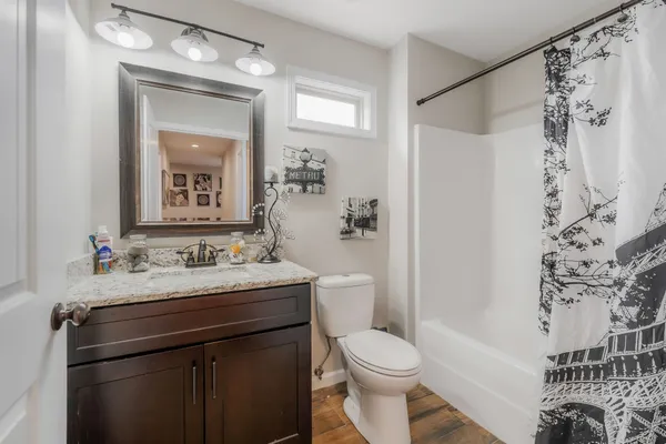 a bathroom with a sink toilet and shower