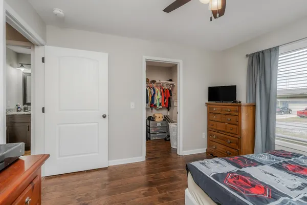 a bedroom with a bed and wooden floor