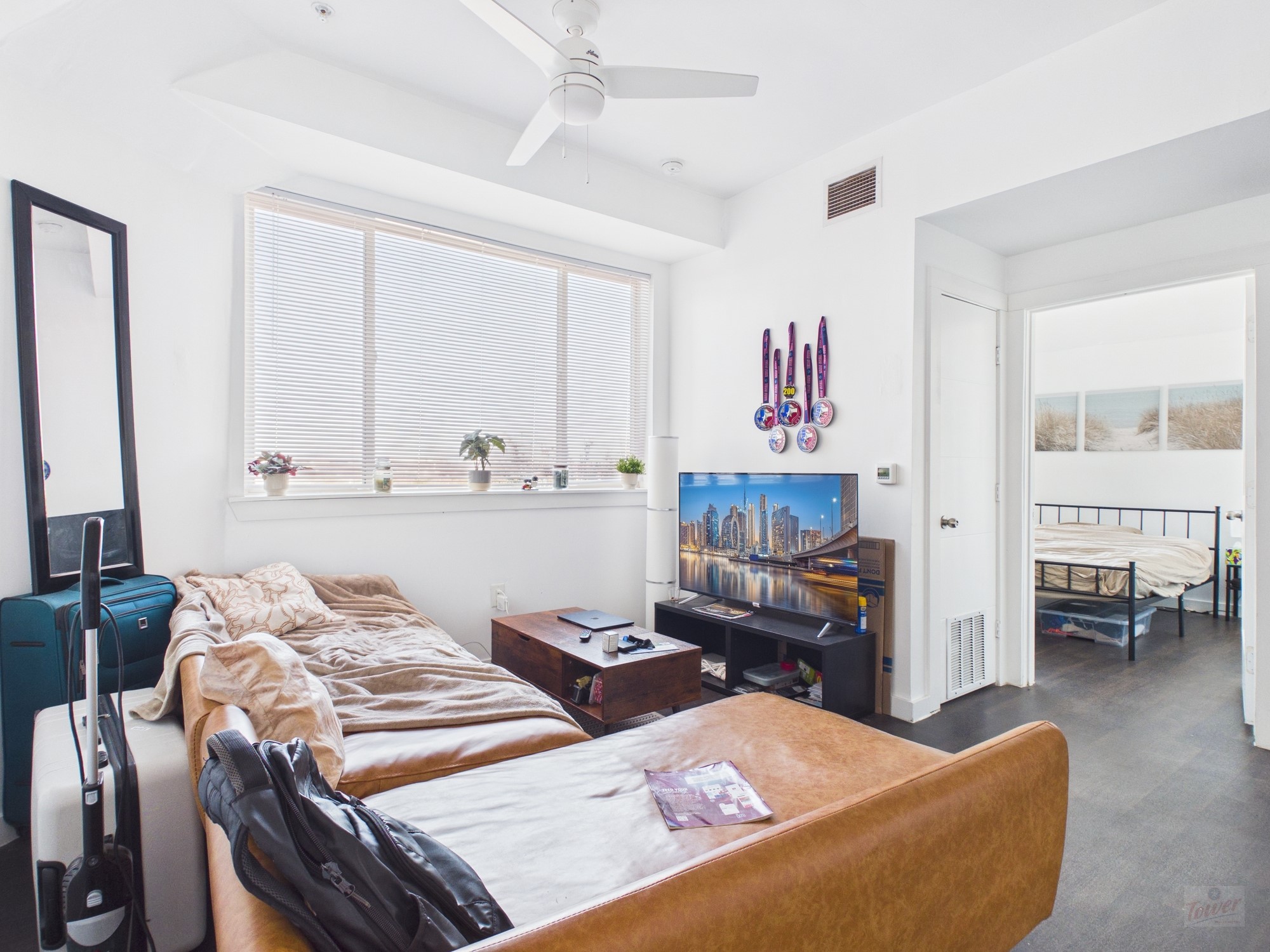1010 West 26th Street, Unit 601 Austin, TX 78705 - Photo 1 of 1 a living room with furniture and a flat screen tv