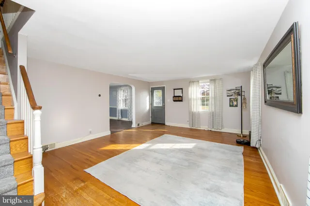 a view of a livingroom with wooden floor and a ceiling fan
