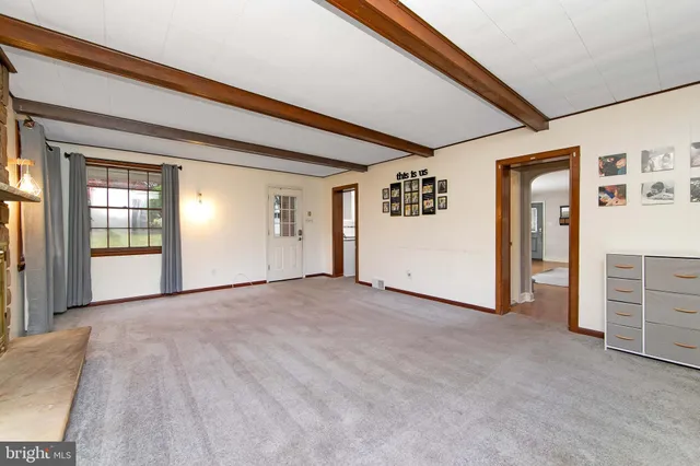 a view of an empty room with a fireplace
