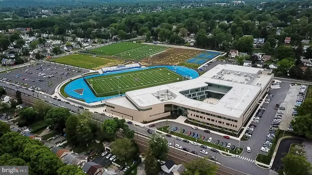 an aerial view of a residential houses with outdoor space