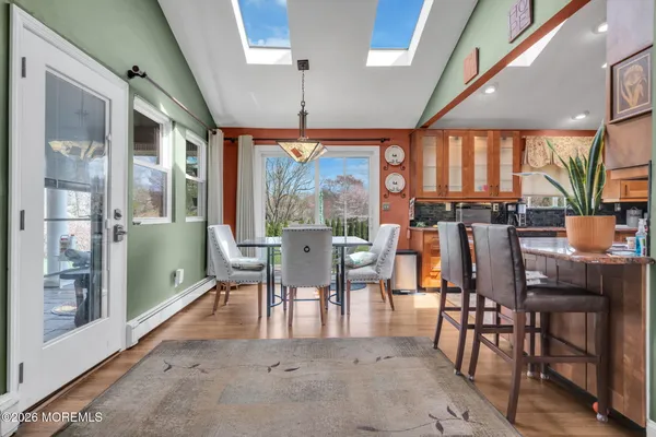a dining room with furniture a chandelier and wooden floor