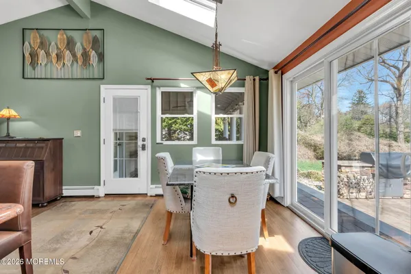 a large kitchen with stainless steel appliances granite countertop a large counter top a stove a sink and a refrigerator