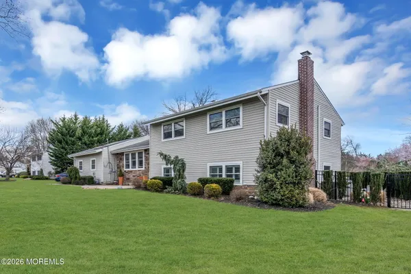 a front view of house with yard and green space