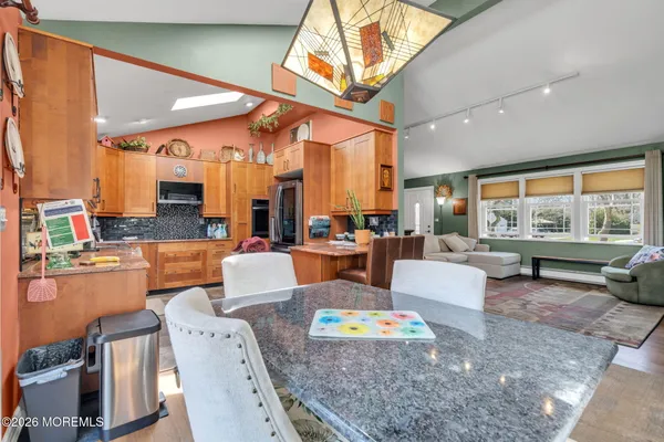 a kitchen with stainless steel appliances granite countertop a refrigerator and a stove top oven