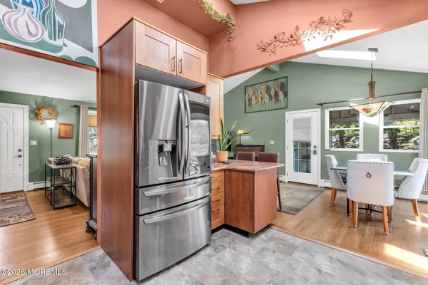 a bed sitting in a spacious bedroom next to a window