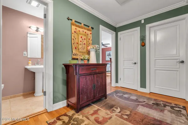 a view of a big room with wooden floor and a ceiling fan