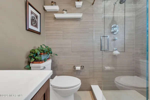 a view of a hallway with staircase and a living room
