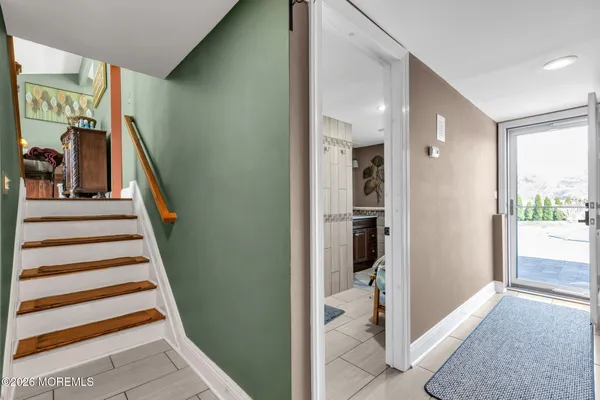 a view of a patio with couches and table and chairs and potted plants