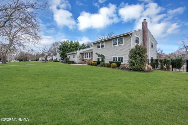 a view of a house with backyard sitting area and garden