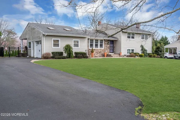a front view of house with yard and green space