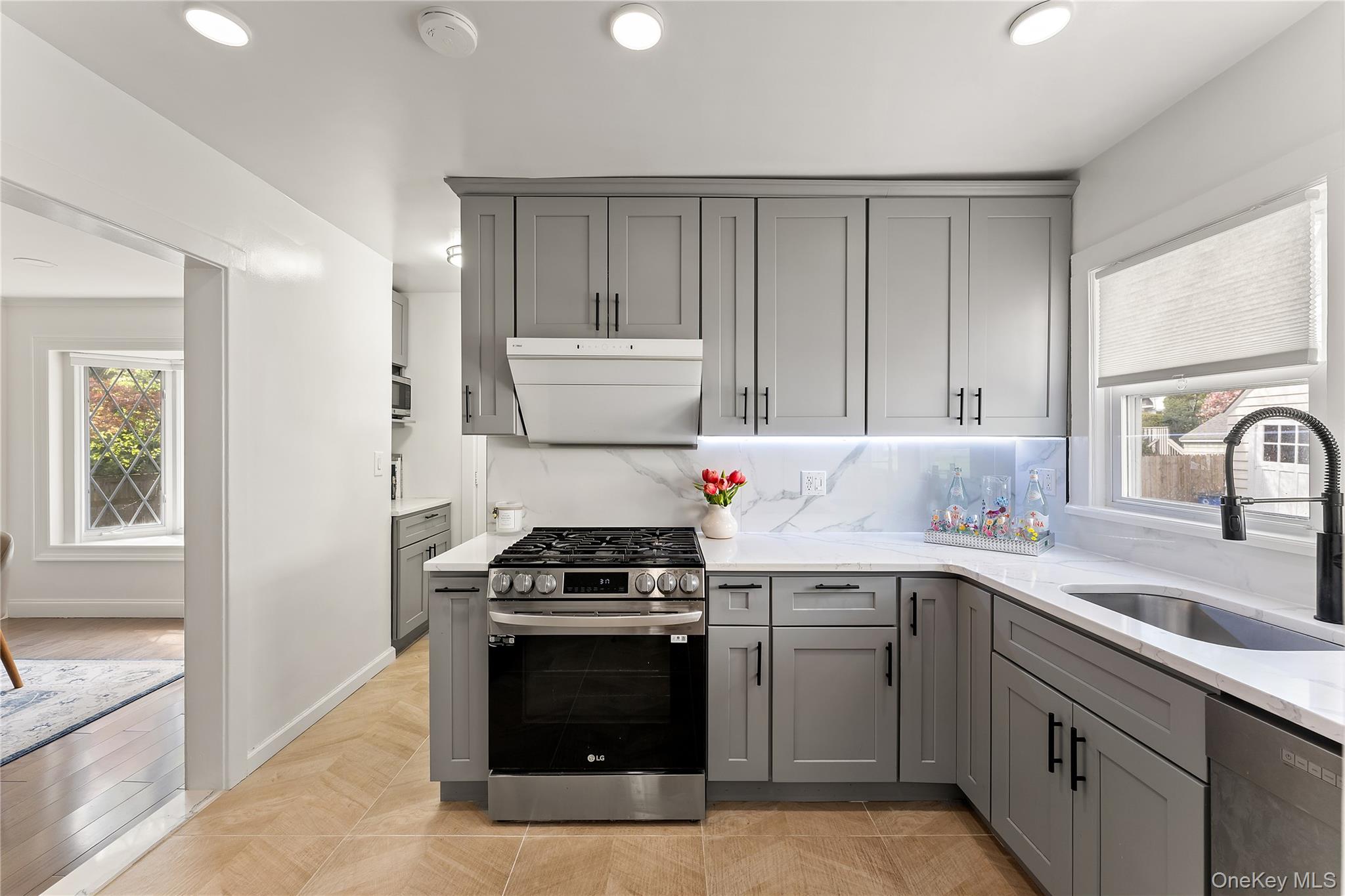 5 Jefferson Road Scarsdale, NY 10583 - Photo 5 of 23 The newly renovated chef's kitchen features premium brand appliances with elegant marble countertops.