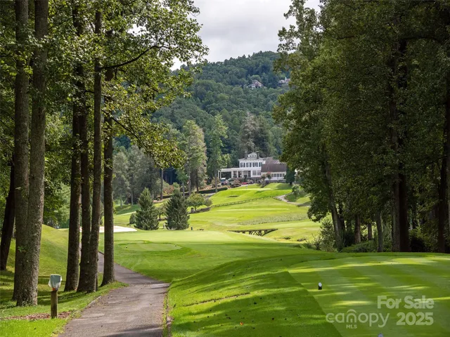 an aerial view of a house with swimming pool and garden