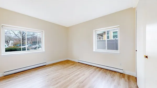 wooden floor in an empty room with a window