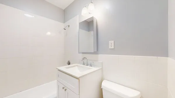 a bathroom with a sink toilet and vanity