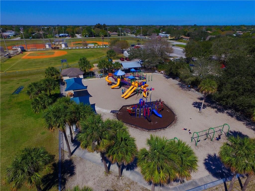 1489 Whitmore Street Sebastian, FL 32958 - Photo 12 of 24 an aerial view of a house with a garden and lake view