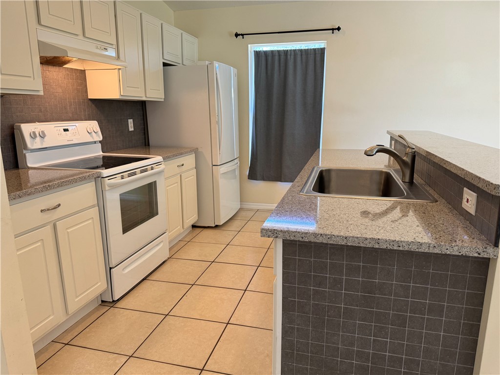 1489 Whitmore Street Sebastian, FL 32958 - Photo 4 of 24 a kitchen with appliances cabinets and a counter top space