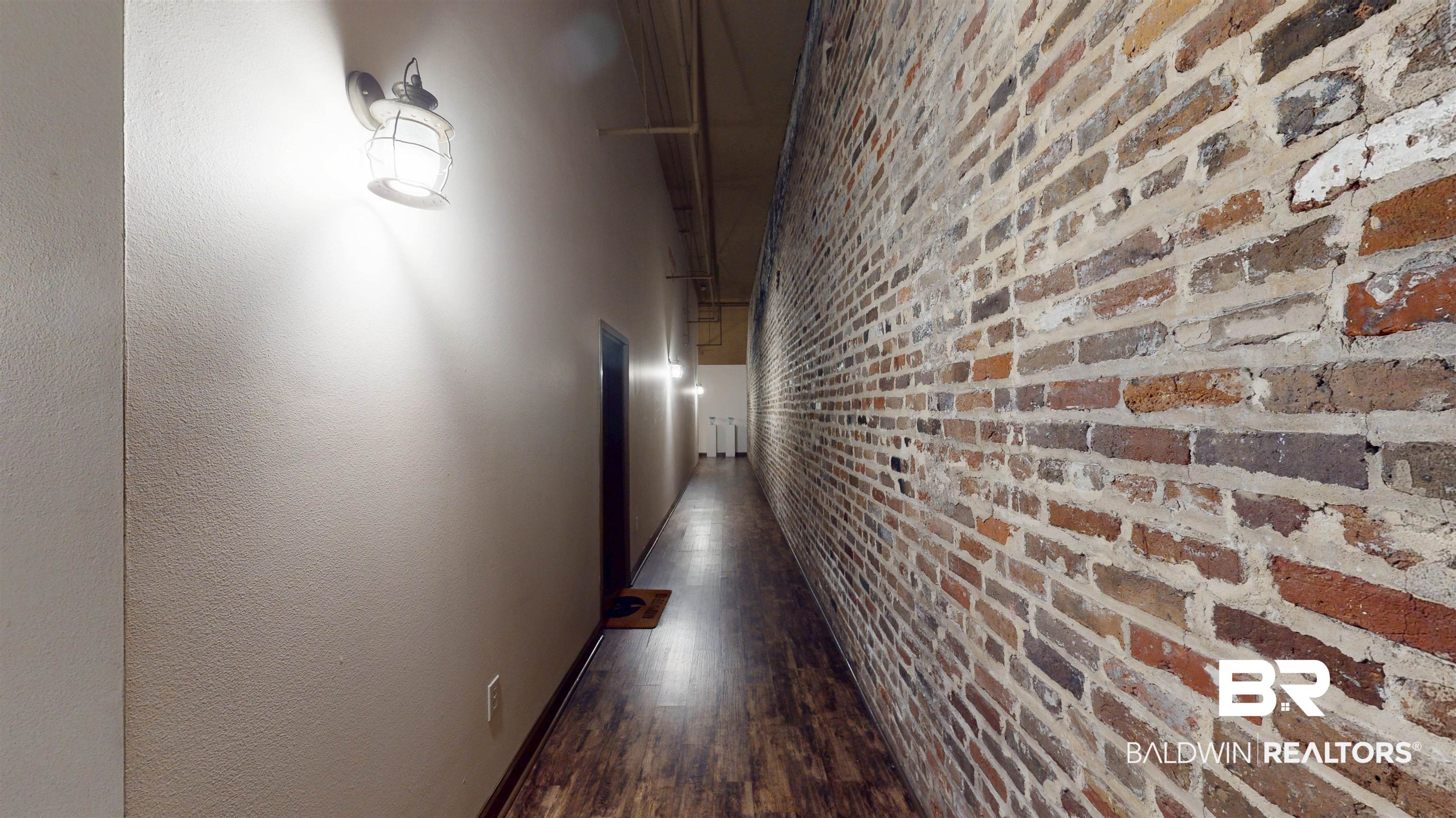 308 St Louis Street, Unit 101 Mobile, AL 36602 - Photo 11 of 30 Hall featuring brick wall and dark wood-type flooring