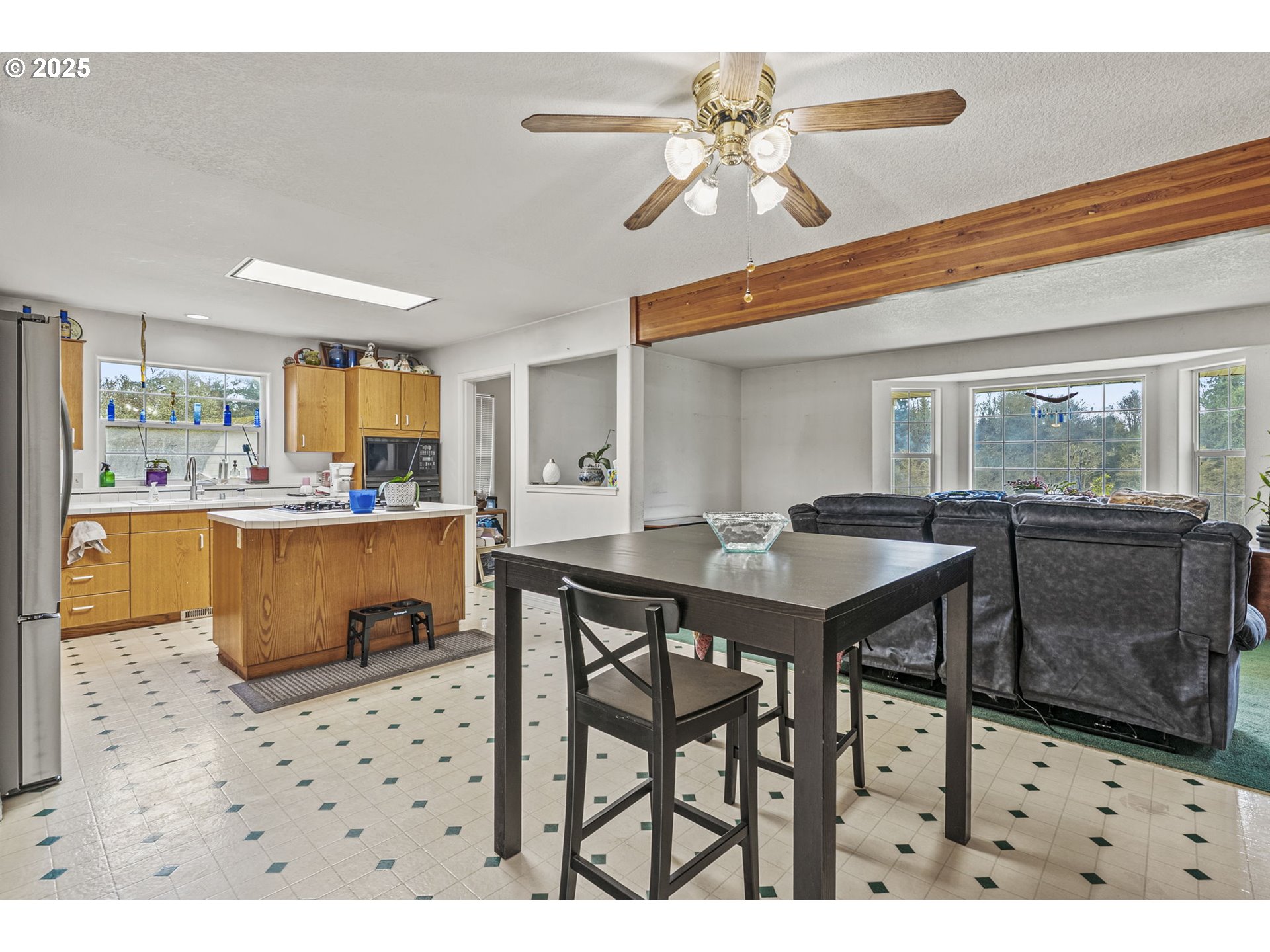 1707 Northwest 354th Street La Center, WA 98629 - Photo 14 of 31 a kitchen with stainless steel appliances kitchen island granite countertop a table chairs and a refrigerator