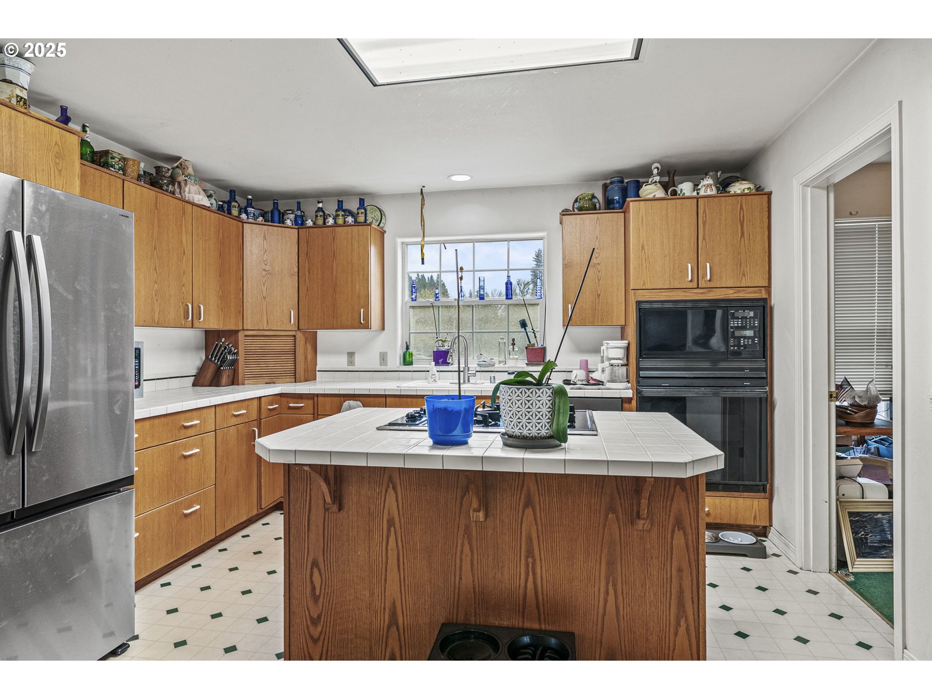 1707 Northwest 354th Street La Center, WA 98629 - Photo 17 of 31 a kitchen with kitchen island granite countertop a sink cabinets and refrigerator