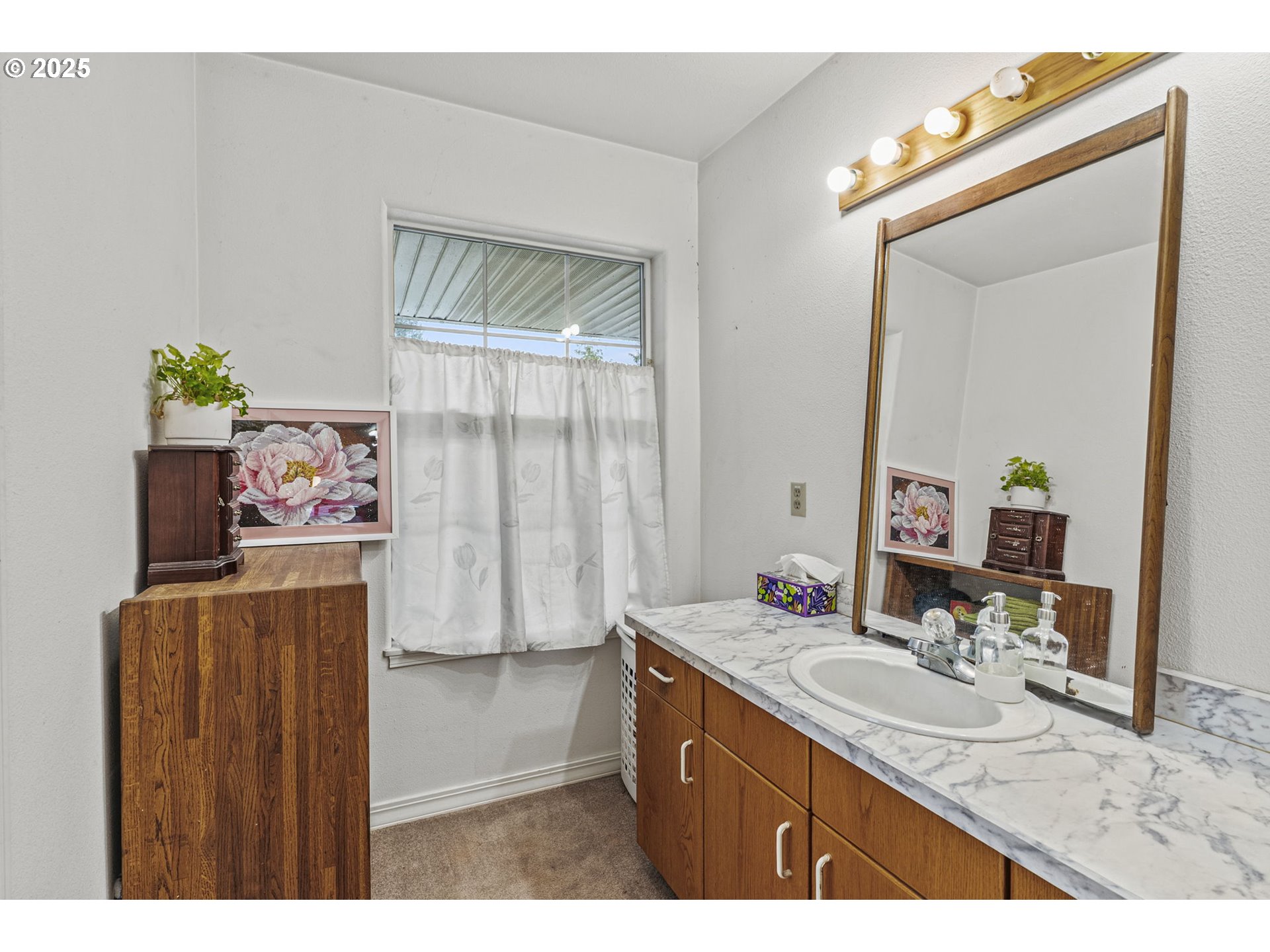 1707 Northwest 354th Street La Center, WA 98629 - Photo 22 of 31 a bathroom with a sink a mirror and a window