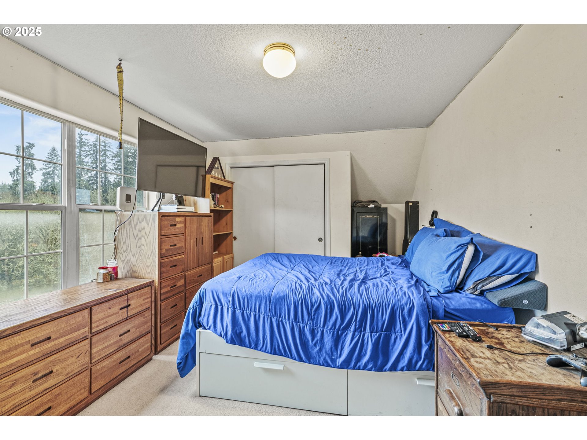 1707 Northwest 354th Street La Center, WA 98629 - Photo 26 of 31 a bedroom with a bed and wooden floor