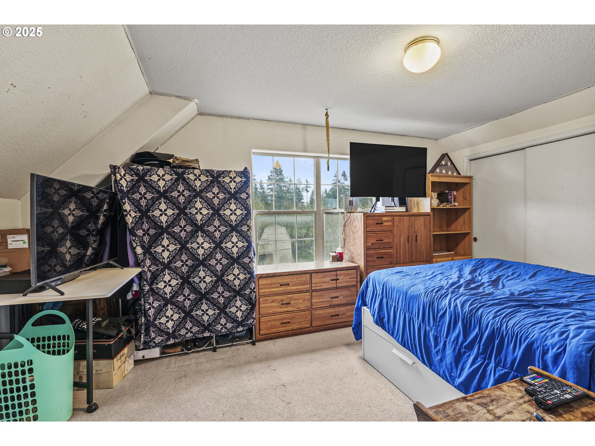 1707 Northwest 354th Street La Center, WA 98629 - Photo 27 of 31 a bedroom with a bed window and a flat screen tv