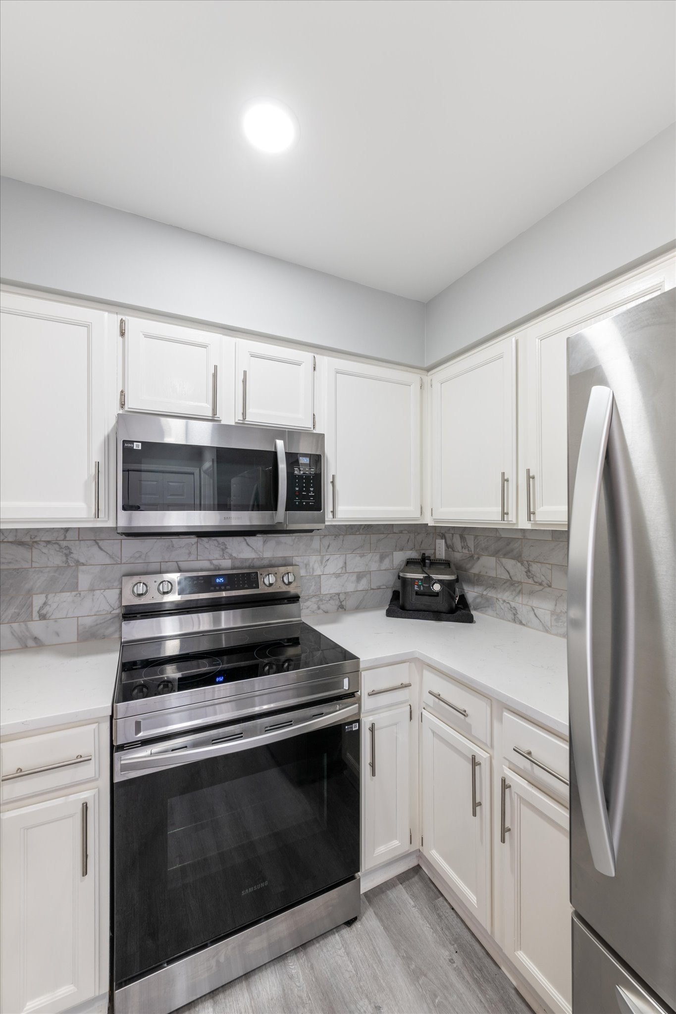 165 Ellington Place Madison, TN 37115 - Photo 11 of 26 a kitchen with stainless steel appliances white cabinets and a stove top oven